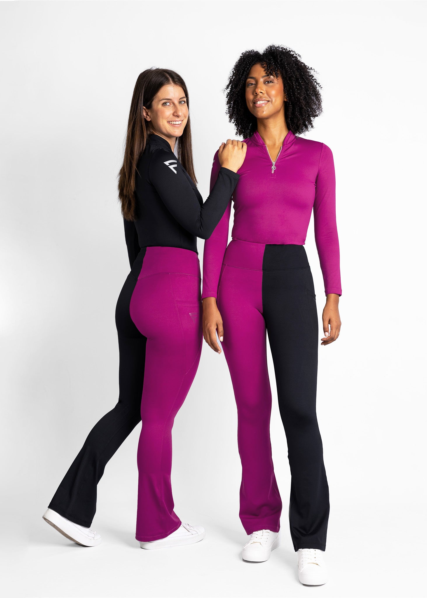 Two ladies wearing our signature Ventura split-colour leggings (wine/black) with our stretchy Cypress Base Layer showcasing our sporty and athletic fits