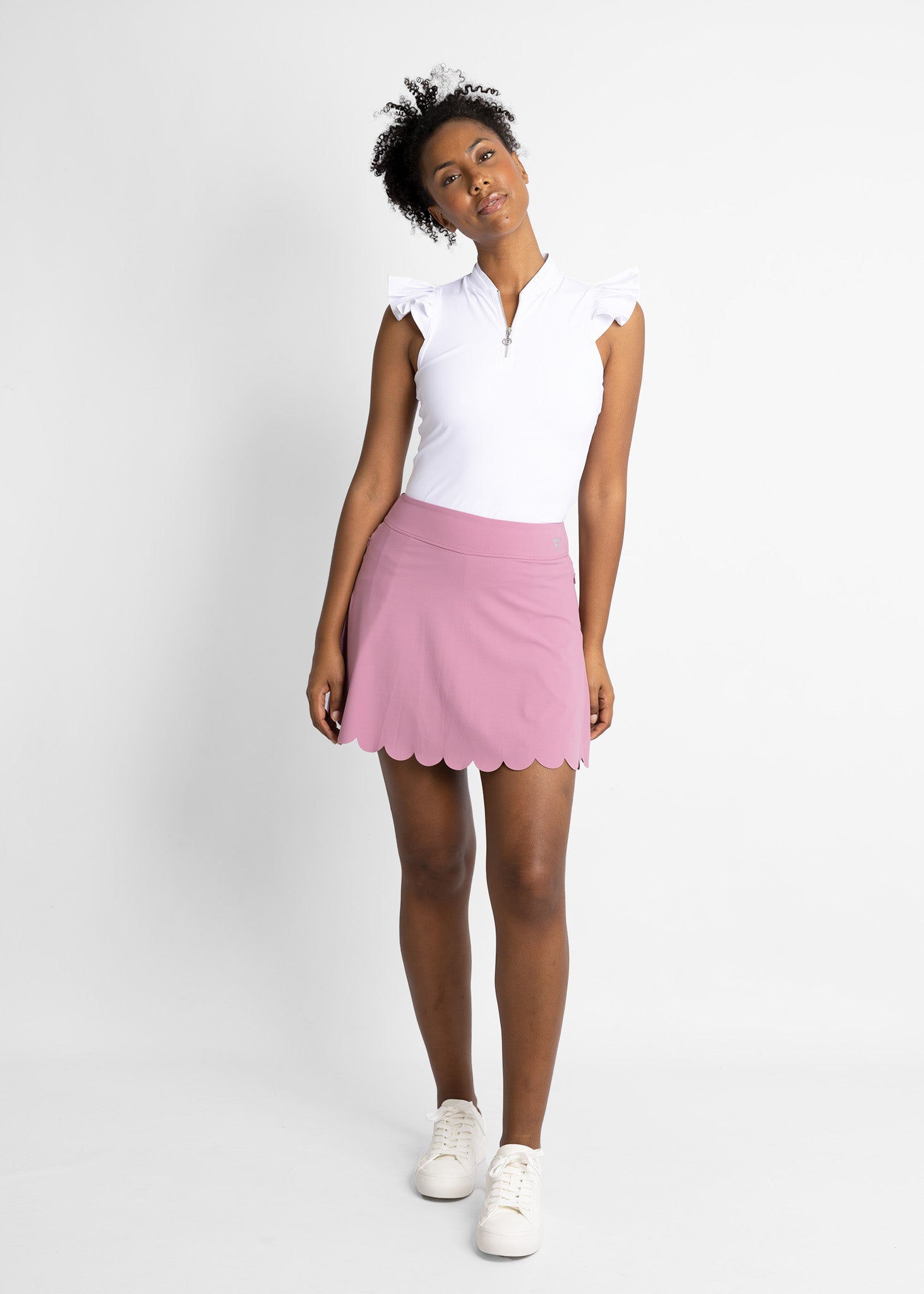 Modern sleeveless golf shirt with ruffle details (colour: white)featured with golf skirt with scallop ending detail (colour: mauve)
