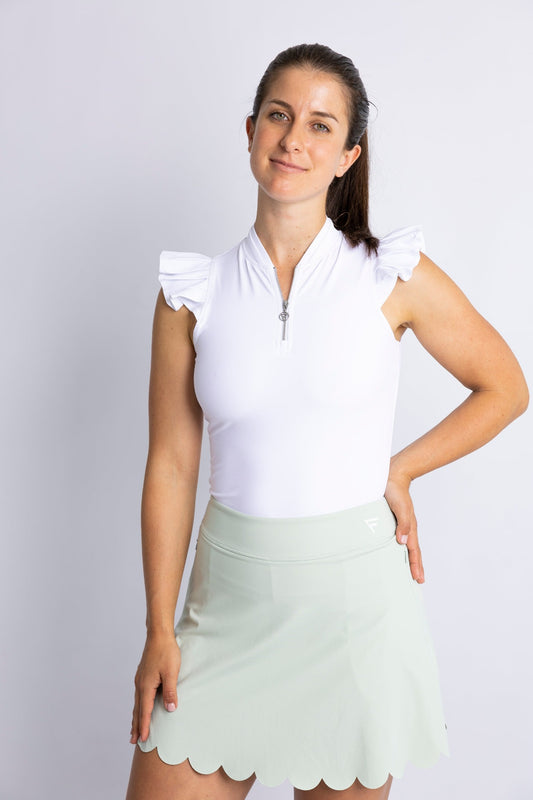 Modern sleeveless golf shirt with ruffle details (colour: white) featured with high-waisted golf skirt (colour:sage green)